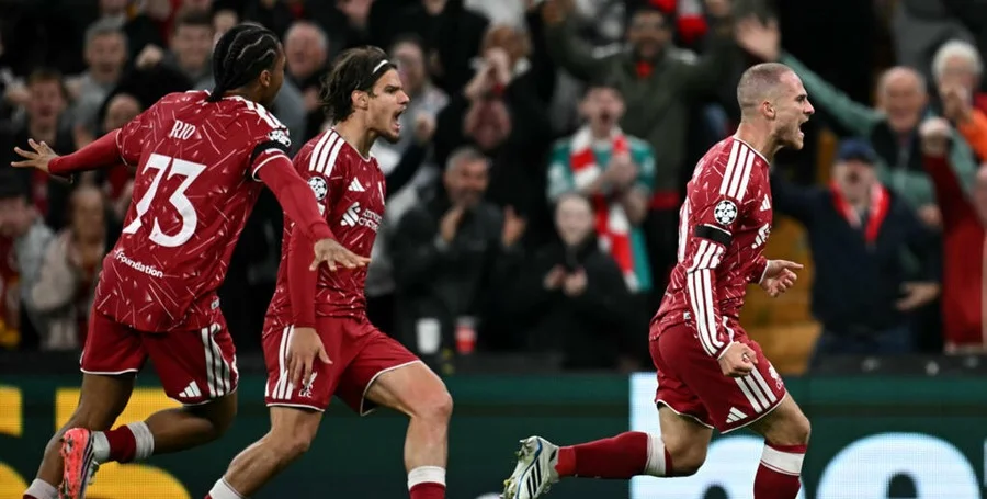 Liverpool players celebrate football goal